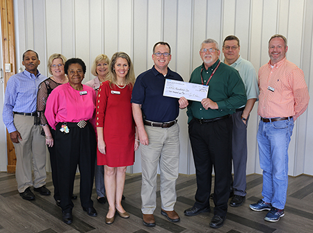 Scott Mixon presents check to NFC Foundation February 2019